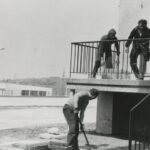 Fotografia przedstawia grupę osób pracujących przy schodach.