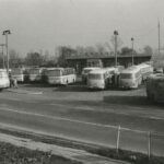 Fotografia przedstawia kilkadziesiąt autobusów stojących na placu przed budynkiem z napisem "Chrzanów".